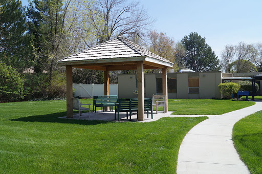 A serene gazebo in a park, surrounded by lush green grass, providing a perfect spot for relaxation.