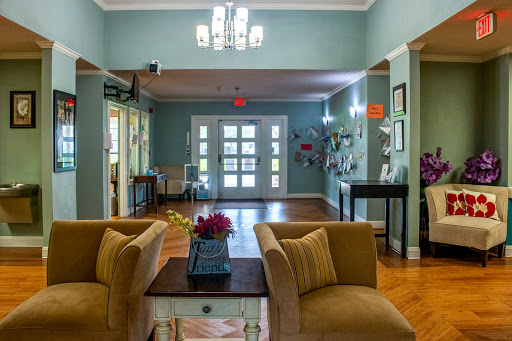 A welcoming lobby area featuring comfortable seating, decorative lighting, and vibrant wall art.
