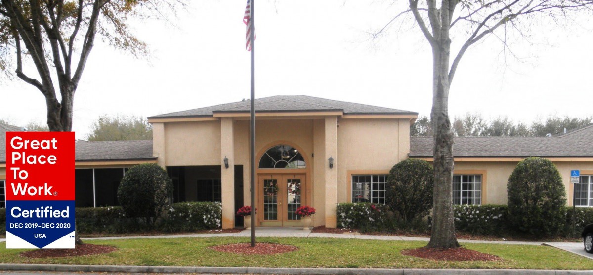 A modest building with an American flag displayed in front of its entrance.