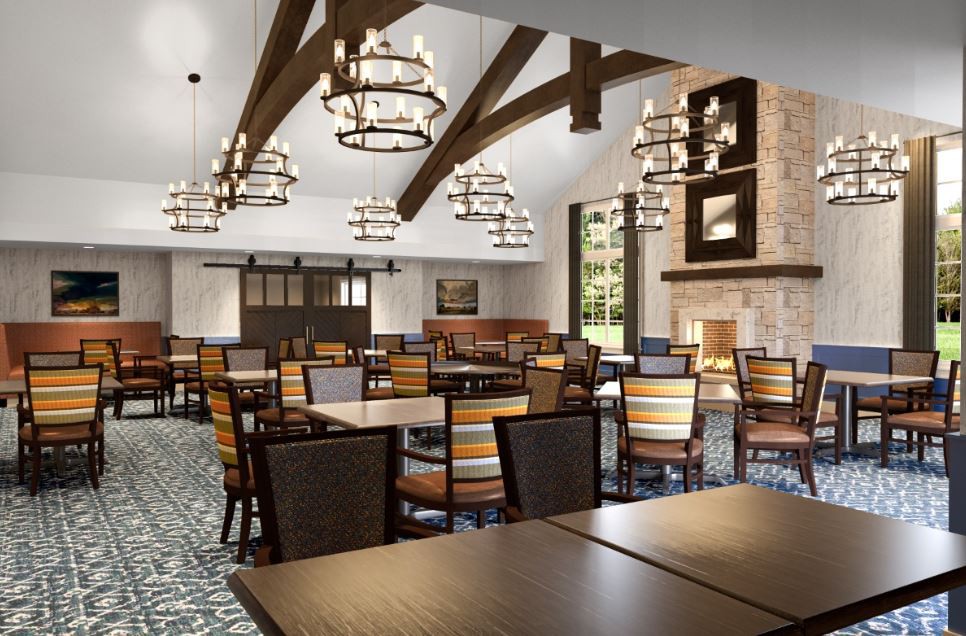 A spacious dining room with wooden furniture, chandeliers, and a large fireplace.