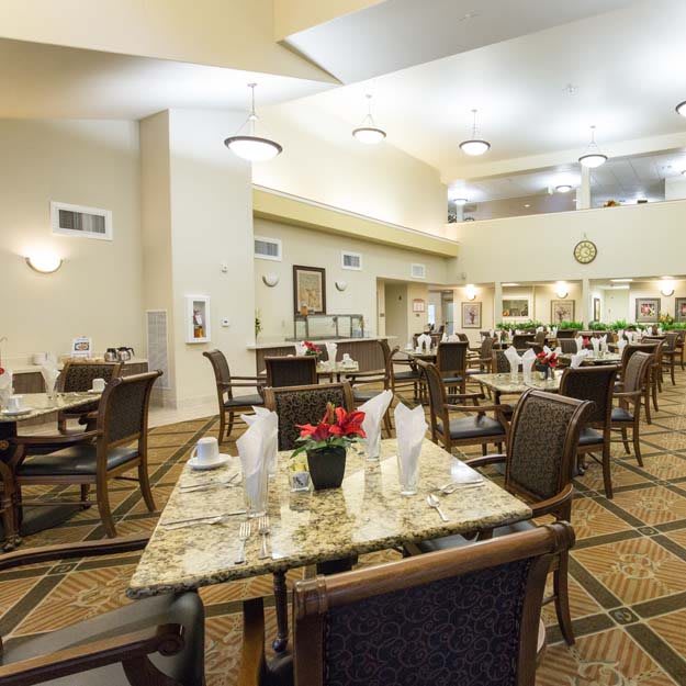 A spacious and well-decorated dining area with multiple tables and chairs.