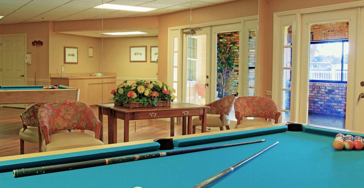A cozy recreation room with a pool table and seating area.