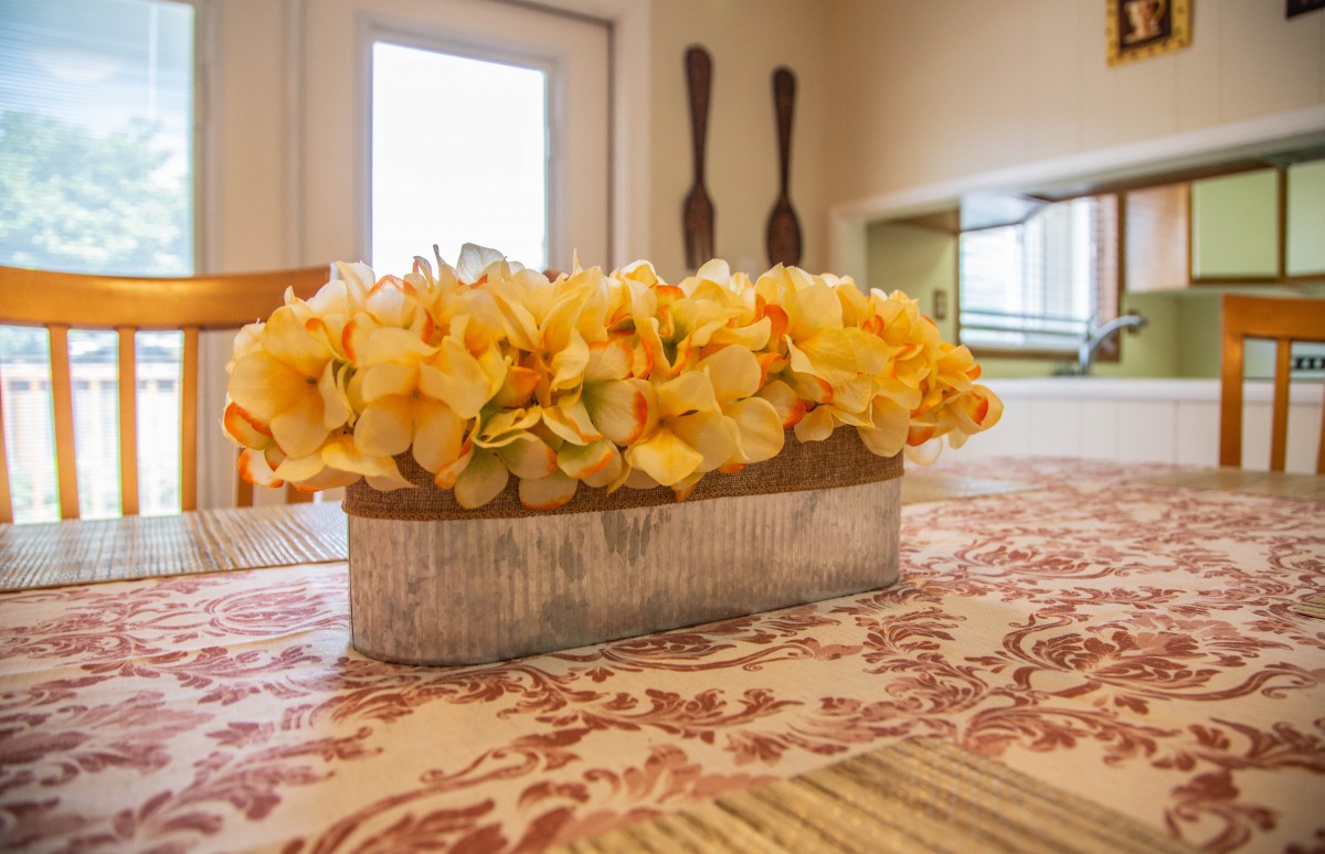 A floral centerpiece adorns a table inside a cozy home.