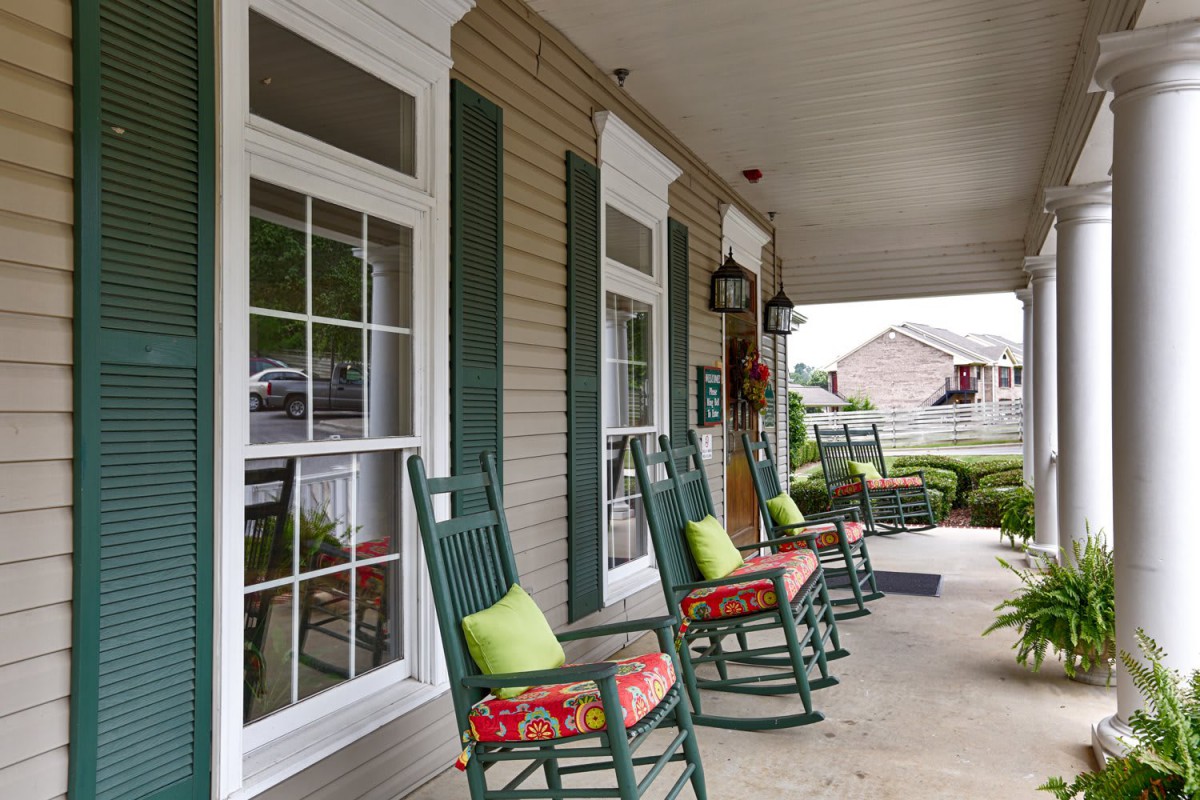 A welcoming porch with rocking chairs and colorful cushions.