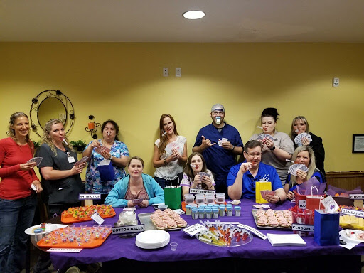 A cheerful group gathers to celebrate with an array of snacks and drinks.