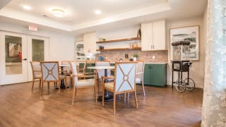 A modern kitchen with a dining area and stylish furniture.