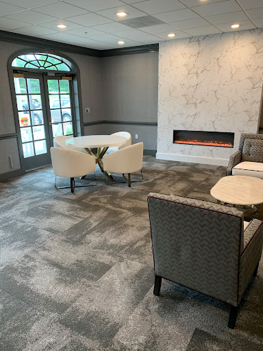 A cozy and modern living room featuring a contemporary fireplace and comfortable seating arrangements.