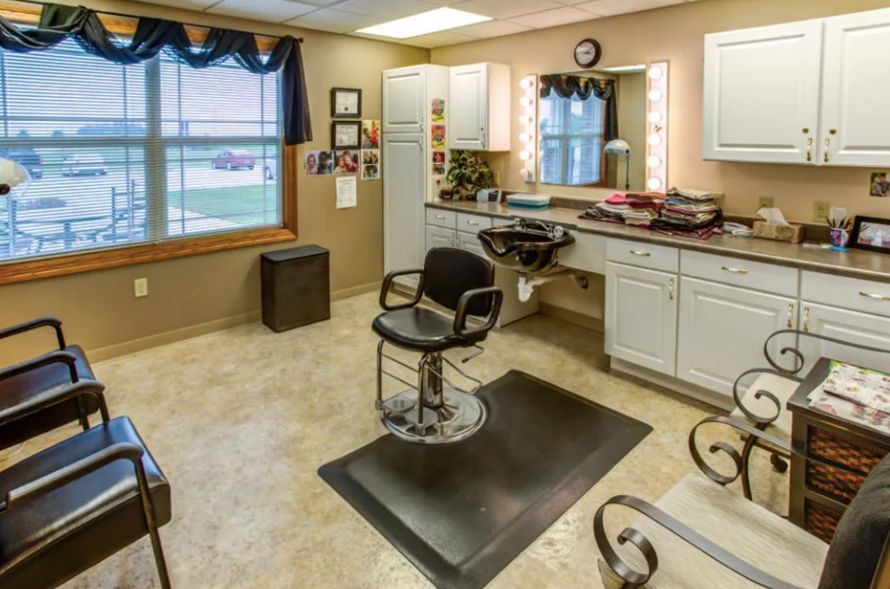 A well-lit hair salon interior featuring a barber chair and styling stations.