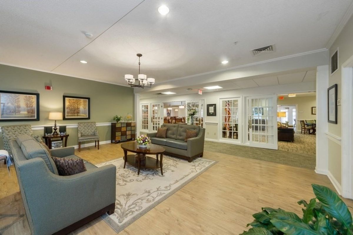 A cozy living room with comfortable seating, a central coffee table, and elegant decor.
