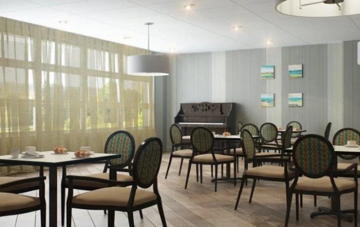 A cozy dining area with elegant chairs and tables, featuring a piano against the wall.