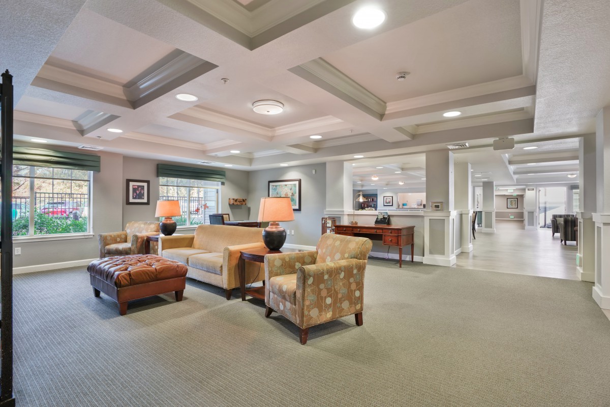 A spacious and elegantly decorated lobby area featuring comfortable seating arrangements.
