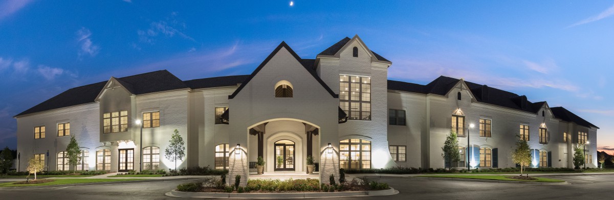A beautifully lit house with symmetrical architecture at dusk.
