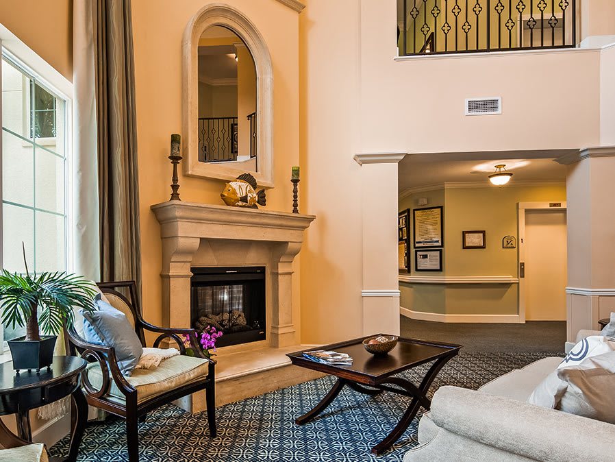 Elegant living room with a fireplace, stylish decor, and comfortable seating.