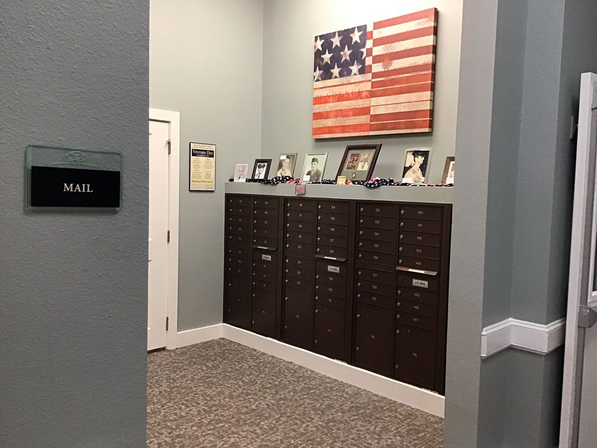 Office interior with an American flag and photo displays on cabinets.