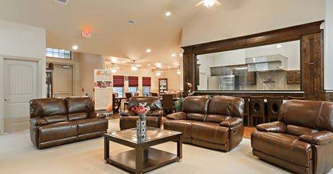 A modern living room with leather sofas and an open layout.