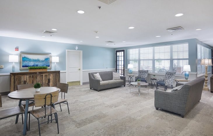 A spacious and modern living room with comfortable seating and ample natural light.