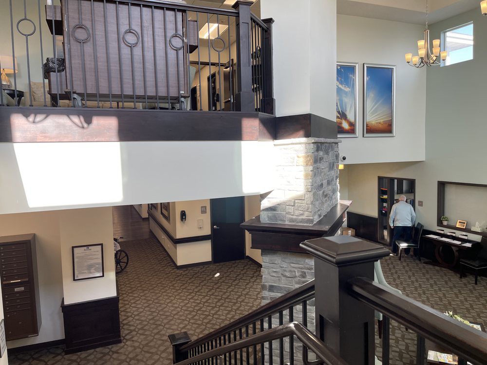 Hotel lobby interior with a staircase and chandelier.