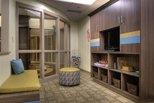 A cozy children's waiting area featuring comfortable seating and playful decor.