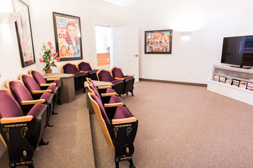 A modern waiting room featuring comfortable seating and vibrant artwork on the walls.