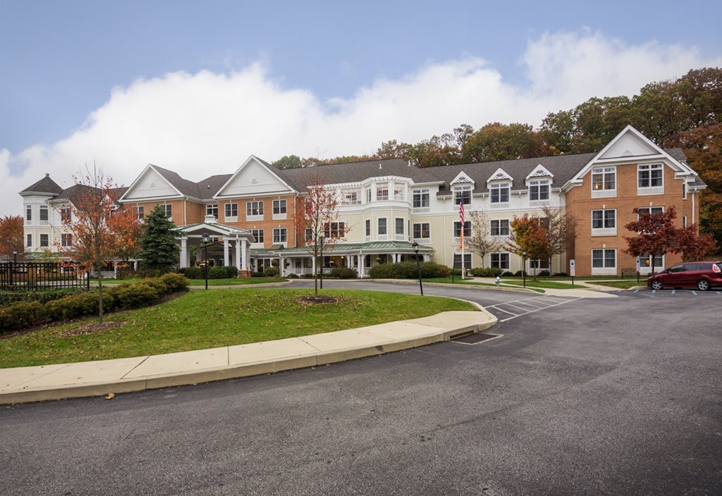 A large residential building with landscaped grounds and a driveway.