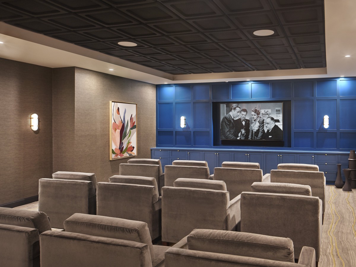 A modern home theater with comfortable seating and a large screen for an immersive viewing experience.
