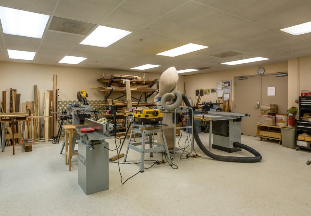 A well-equipped woodworking workshop with various tools and machines.