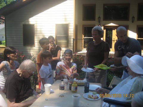 Family enjoying an outdoor gathering on a sunny day.