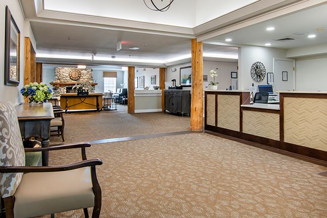 A spacious lobby with a reception desk and comfortable seating areas.