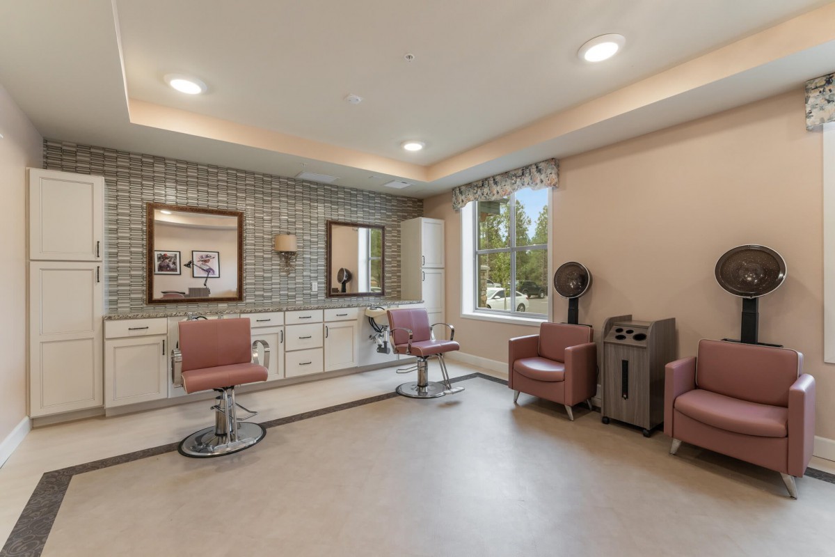 A modern salon interior featuring styling chairs and mirrors, with a warm and welcoming atmosphere.