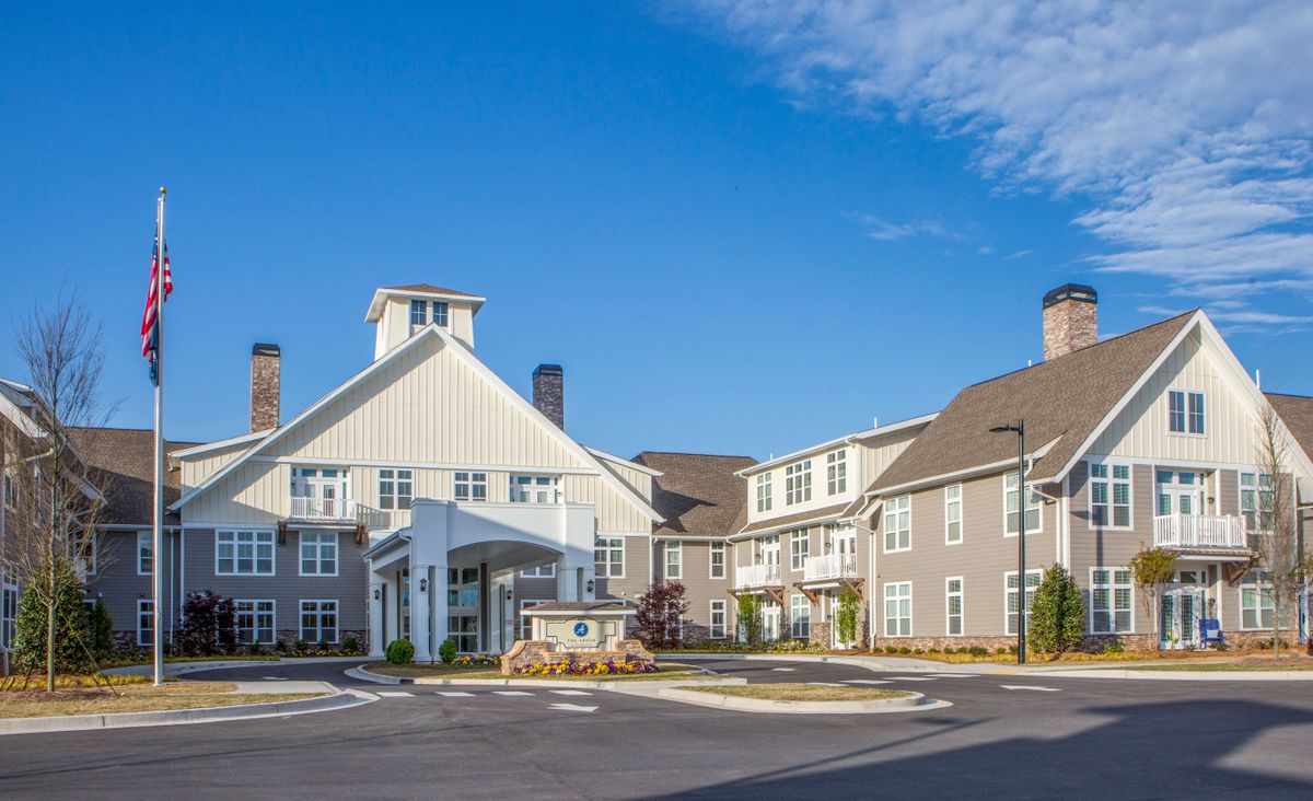 A modern residential building under a clear blue sky.