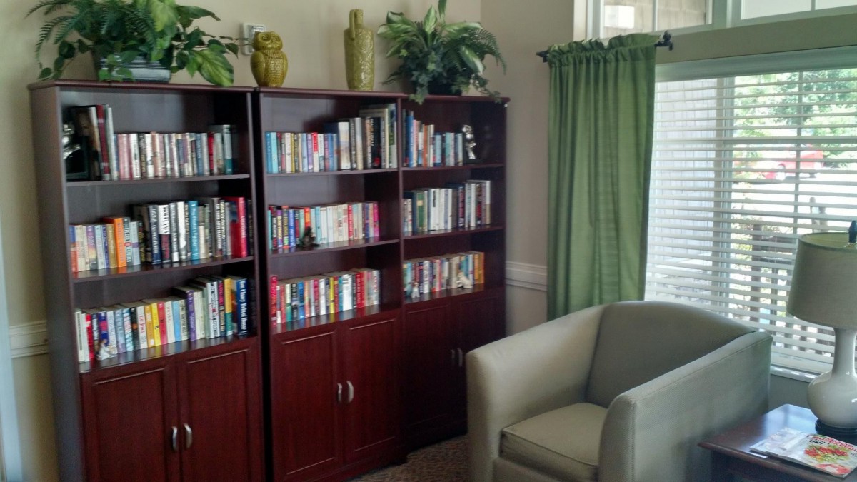 A cozy reading corner with a well-stocked bookshelf and a comfortable armchair.