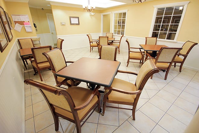 Empty dining area with several tables and chairs arranged neatly.