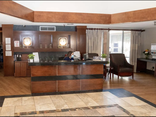A welcoming hotel lobby featuring a sleek reception desk and comfortable seating.