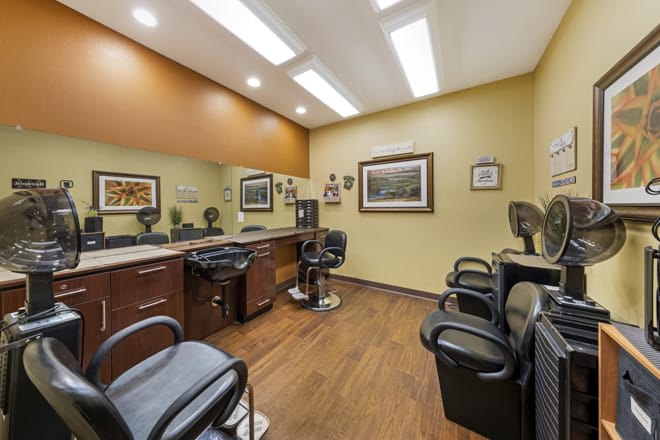 A well-lit barbershop interior featuring multiple chairs and mirrors.