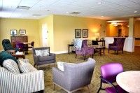 A cozy lounge area with various seating options and warm lighting.