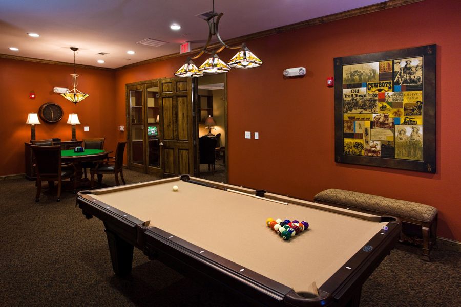 A cozy game room featuring a billiards table and ambient lighting.