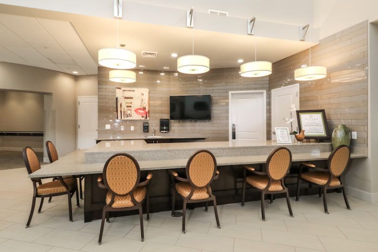 A modern kitchen interior with a sleek counter and elegant seating.