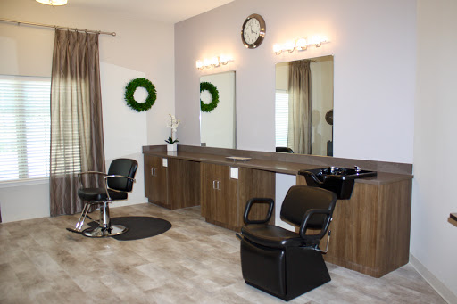 A stylish and modern hair salon featuring comfortable seating, well-lit mirrors, and a welcoming aesthetic.