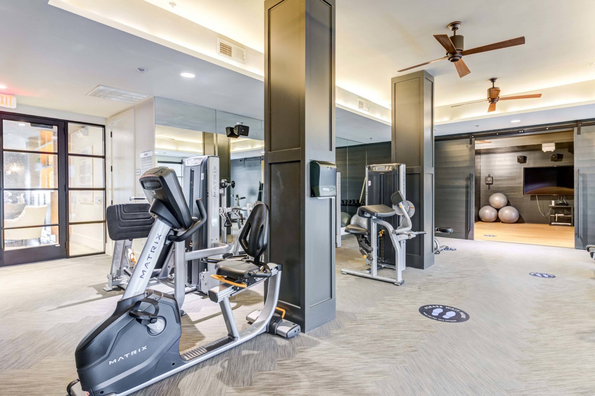 A modern gym with various exercise equipment.
