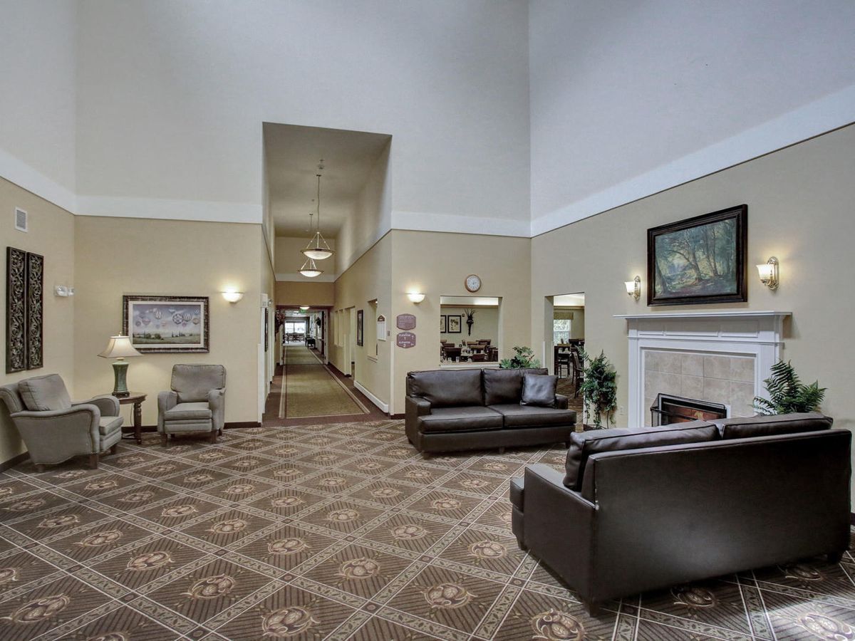 A spacious lobby area featuring comfortable seating and a cozy fireplace.