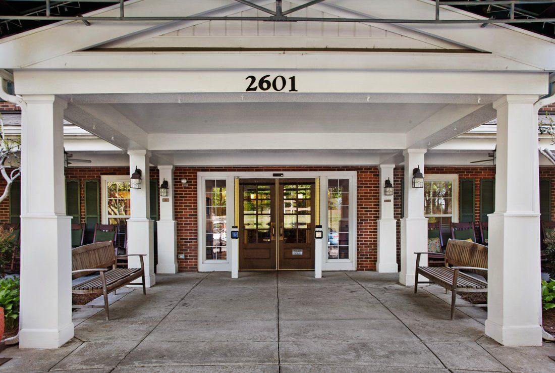 Front entrance of a building with benches and clearly visible address number 2601.