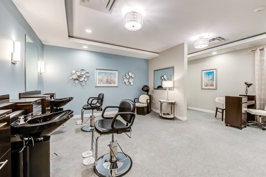 A modern hair salon interior with multiple styling chairs and mirrors.