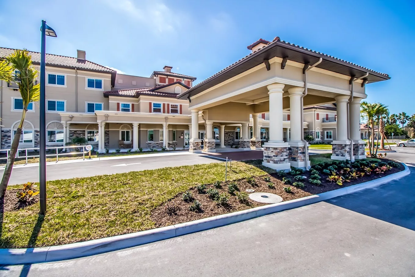 A modern building with a covered entrance and well-maintained landscaping.