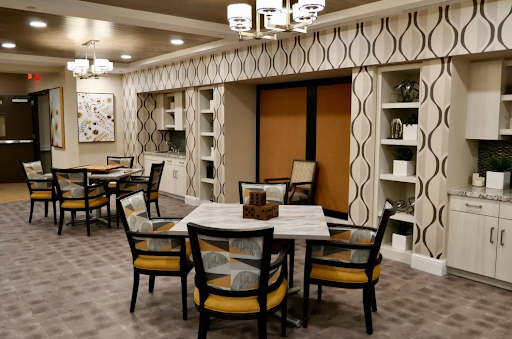 A modern dining area featuring stylish furniture and patterned walls, designed for a welcoming living space.