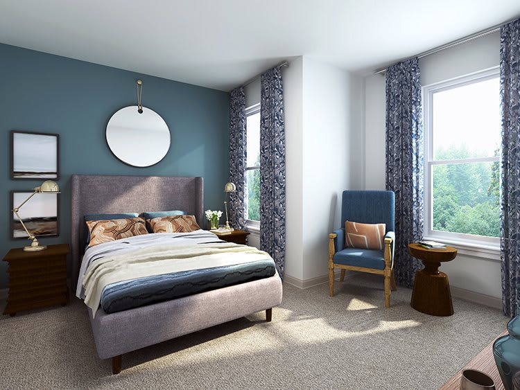 A modern bedroom with a comfortable bed, stylish furniture, and large windows letting in natural light.
