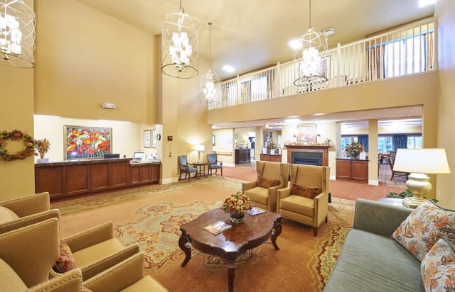 Spacious lobby with comfortable seating and elegant chandeliers.