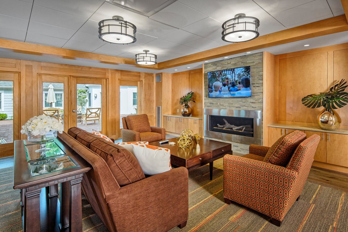 A cozy living room with modern decor, featuring a fireplace and comfortable seating.