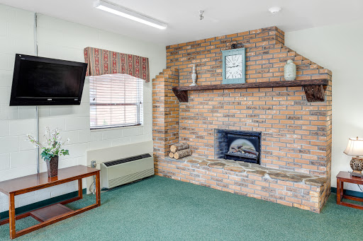 Cozy living room featuring a brick fireplace and modern furnishings.