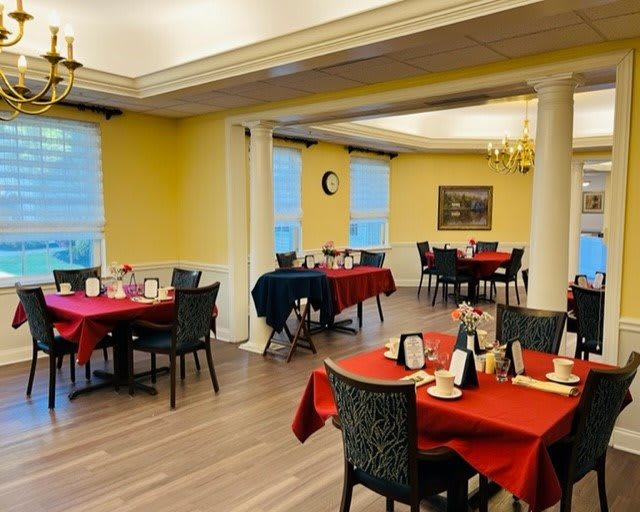 A cozy dining room with elegantly set tables and a warm ambiance.