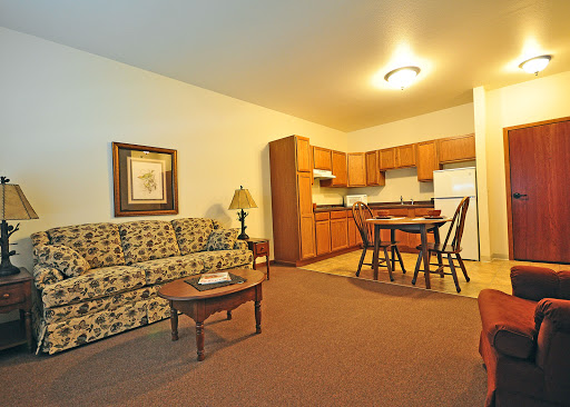 A cozy apartment featuring a living room and kitchenette, perfect for comfortable living.